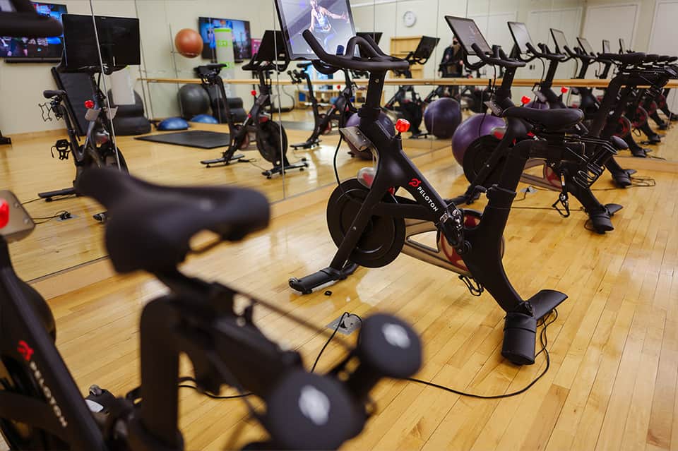 Spinning class studio with stationary bikes and monitors