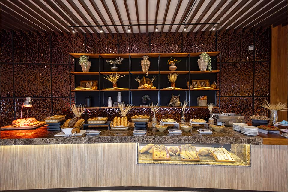 Upscale bakery display with breads, pastries, decorative panels, and organized shelving