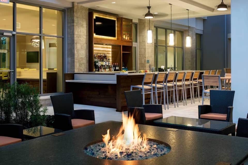 Contemporary outdoor bar and firepit lounge area with modern seating