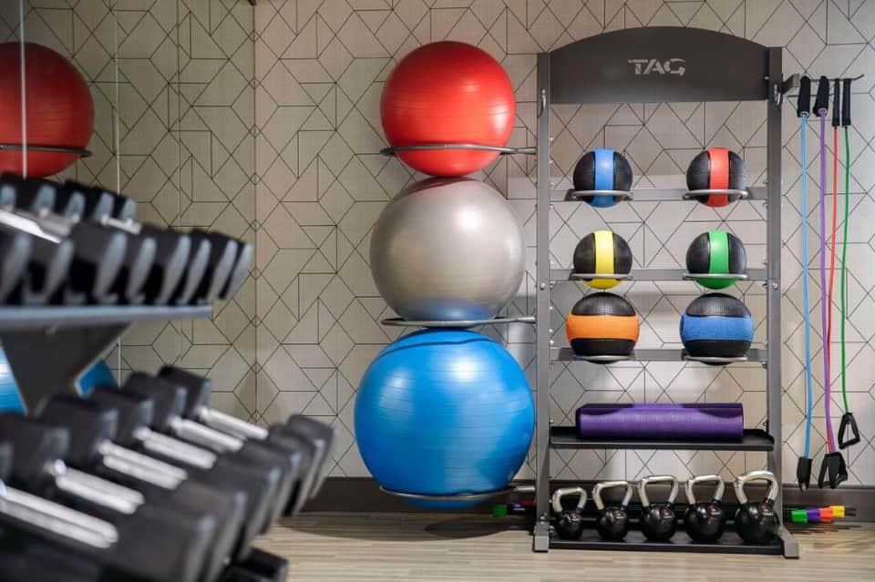 Fitness center with colorful exercise balls, weights, and strength training equipment