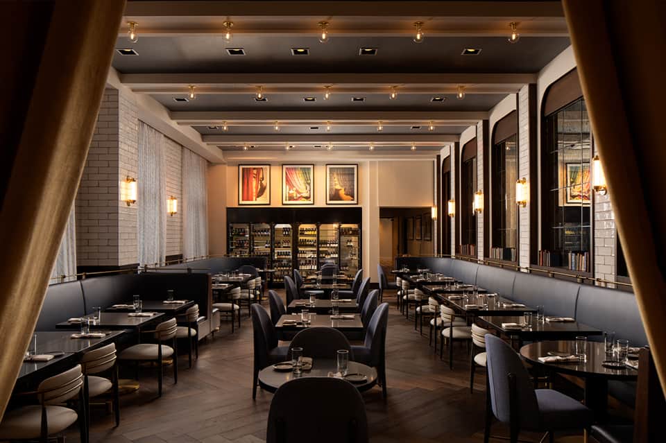 Modern fine dining restaurant with black tables, mirrored walls, and contemporary upscale design