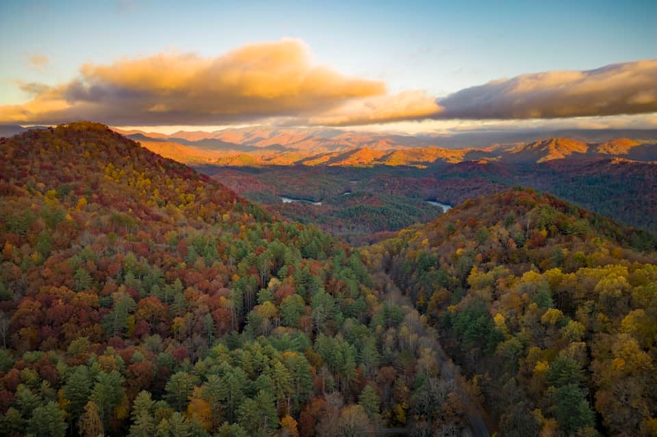 Scenic mountain landscape with forested hills and distant valleys at sunset