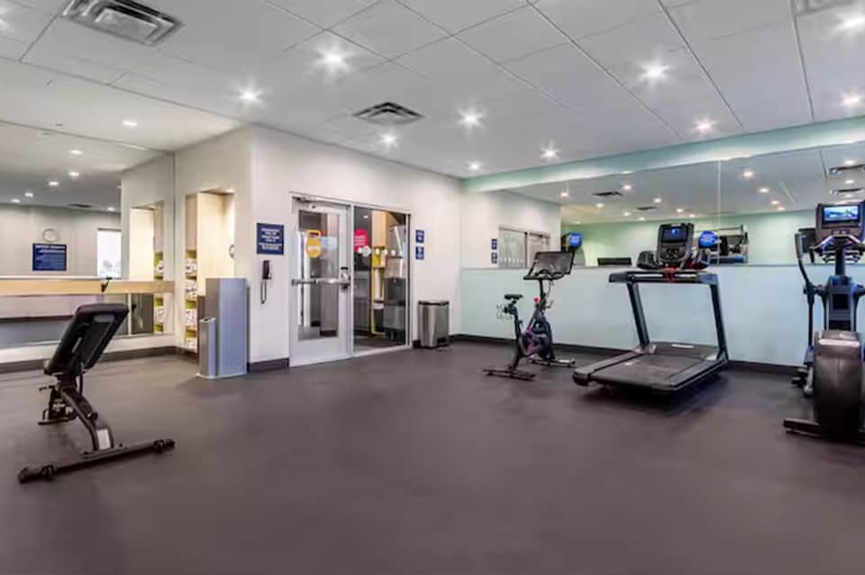 Fitness center with cardio equipment including treadmills, stationary bikes, and exercise machines