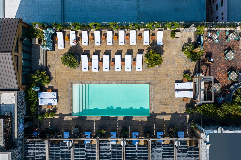 Aerial view of modern urban pool deck with loungers and geometric layout