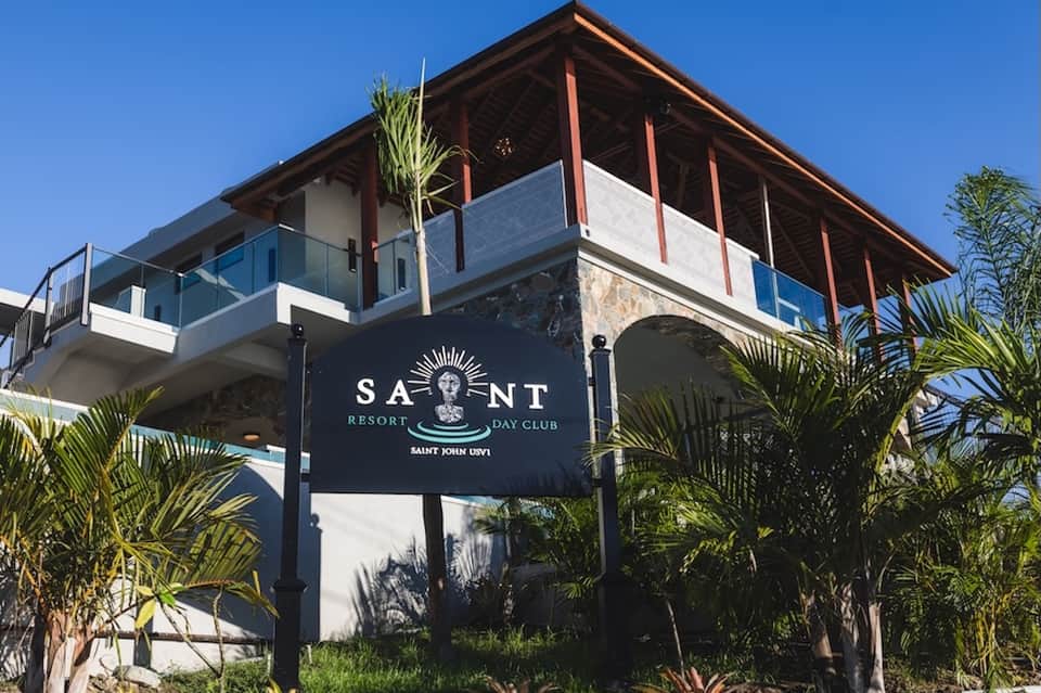 Saint Resort and Day Club modern elevated building with palm trees and wooden railings