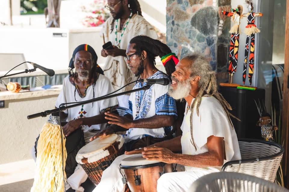 Local musicians performing with traditional instruments at indoor resort venue