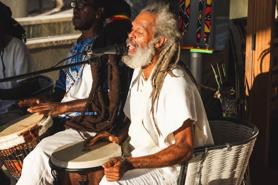 Men playing drums during cultural performance or entertainment event at resort venue