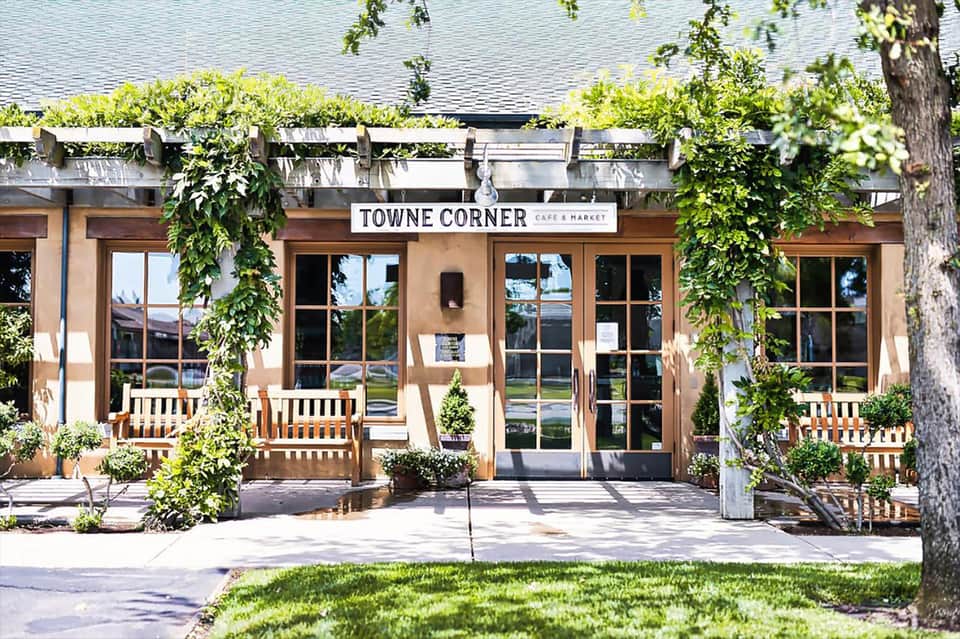 Towne Corner Cafe & Market storefront with ivy-covered entrance and wooden benches