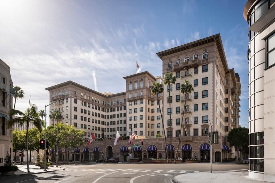 Historic downtown plaza with classic architectural buildings and palm trees