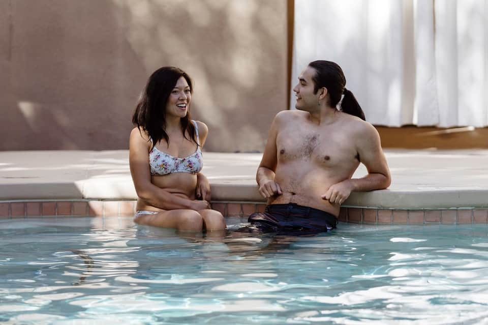 Couple relaxing in warm spa pool, enjoying wellness amenities at resort