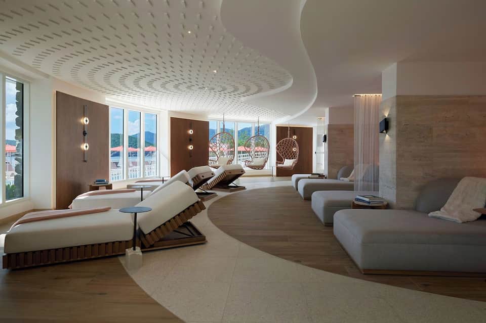 Luxury spa relaxation room with curved ceiling, loungers, and ocean views