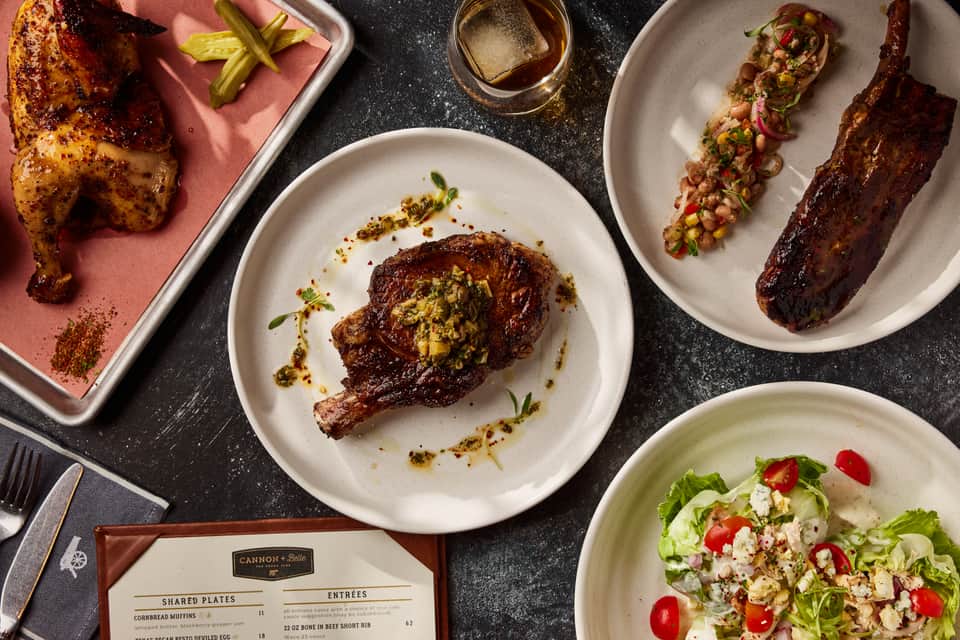 Upscale restaurant dishes featuring grilled meats, fresh salads, and refined plating on white plates