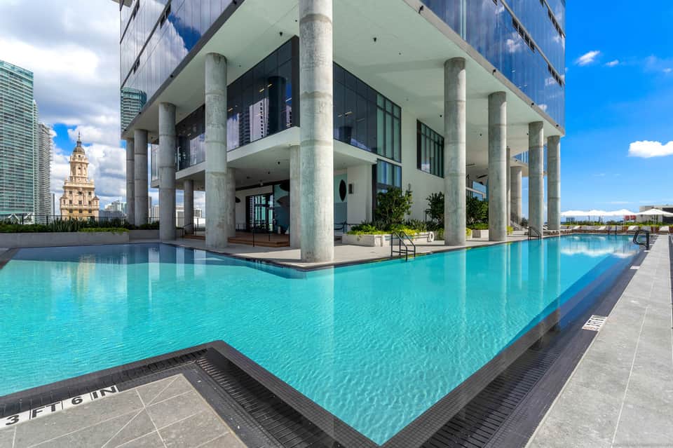 Contemporary rooftop infinity pool with city skyline and architecture