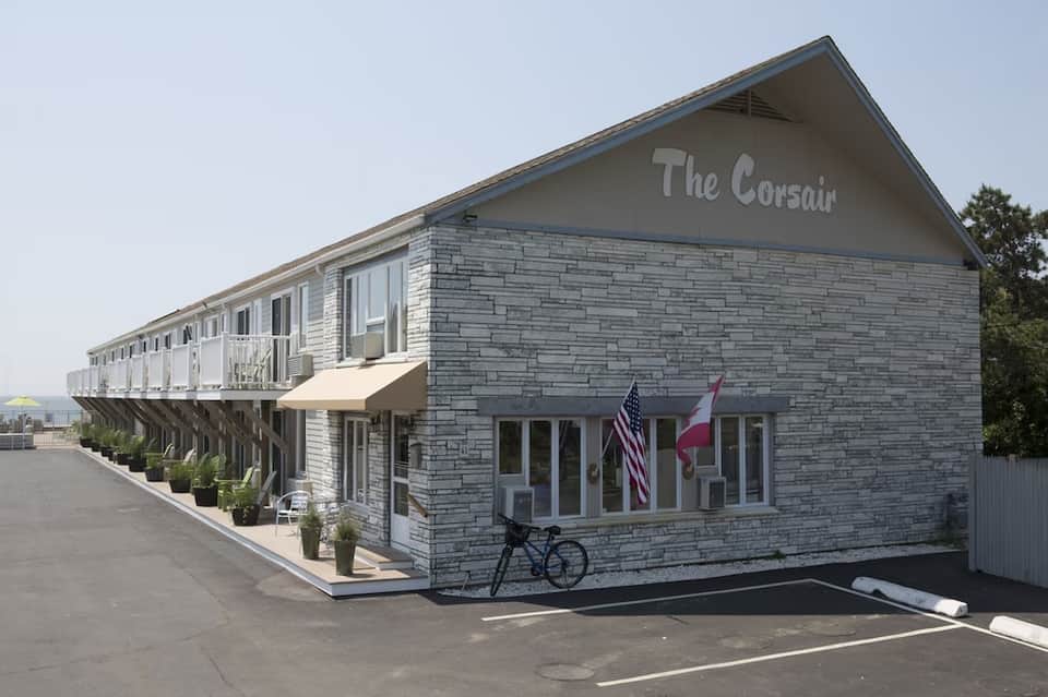 The Corsair beachfront building with white railings and American flag