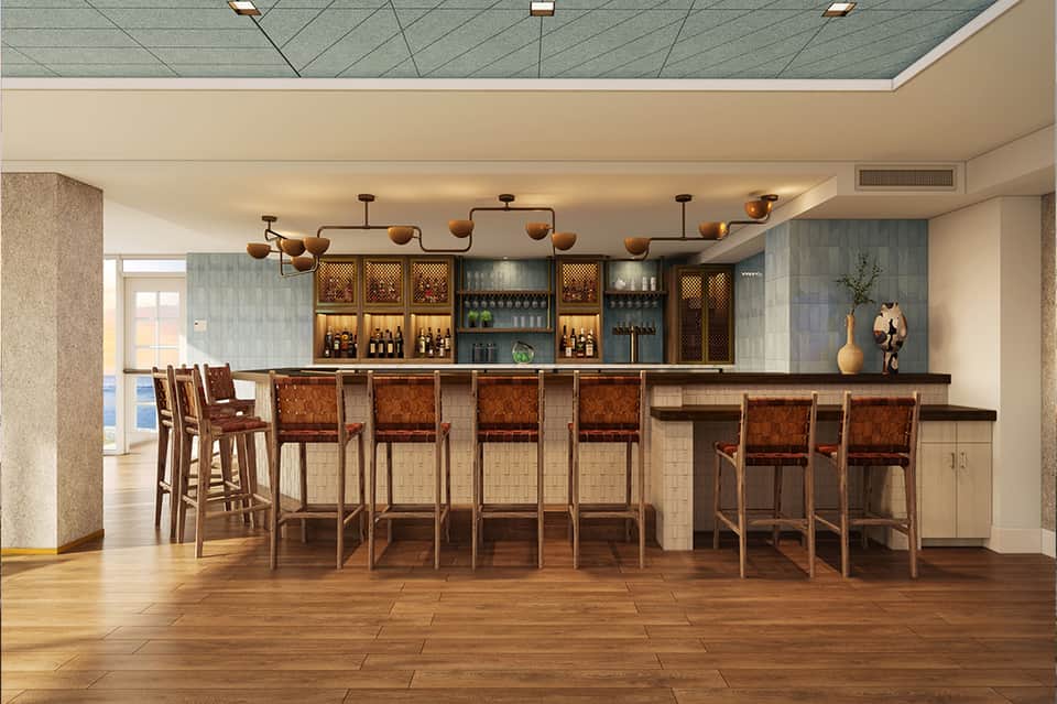 Upscale hotel bar with copper pendant lights, wood furnishings, and modern design