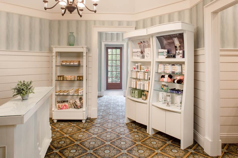 Luxury spa retail boutique with white shelving displaying skincare products