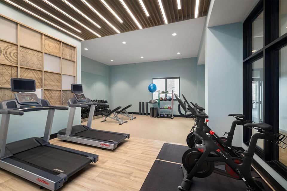 Modern fitness center with treadmills, stationary bikes, and contemporary design