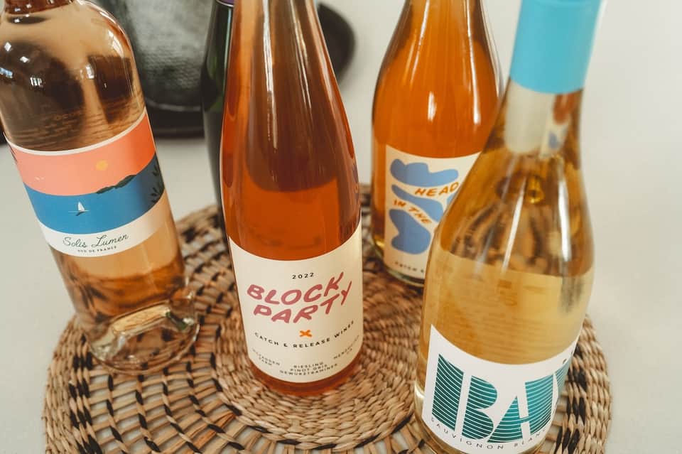 Selection of craft beverages including rosé wine, riesling, and local brewery bottles