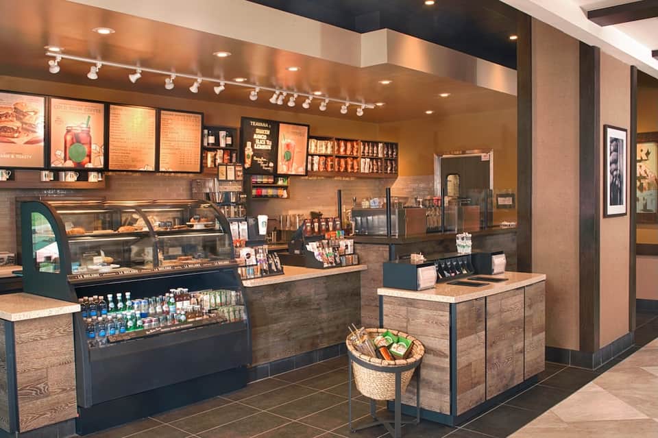 Modern coffee shop interior with display cases, menu boards, and serving counter