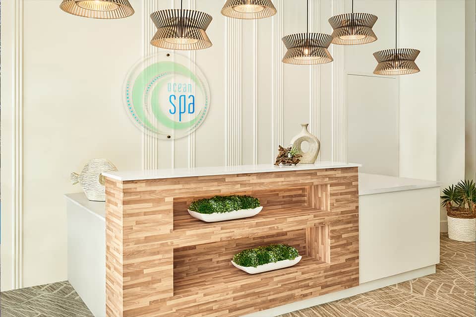 Modern spa reception desk with Ocean Spa sign and wooden fixtures