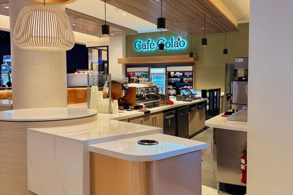 Modern café interior with Café Colao signage, counter service, and contemporary lighting