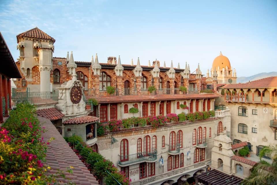 Spanish colonial-style resort courtyard with ornate red brick architecture and manicured gardens