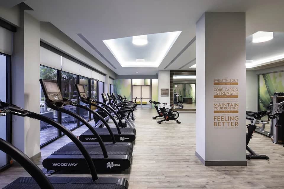 Contemporary fitness facility with cardio equipment and motivational wall signage