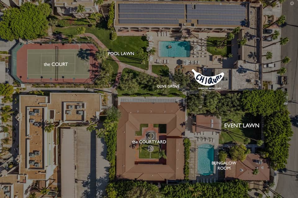 Aerial view of resort grounds showing pool, tennis court labeled 'the COURT', lawn areas, and building layout