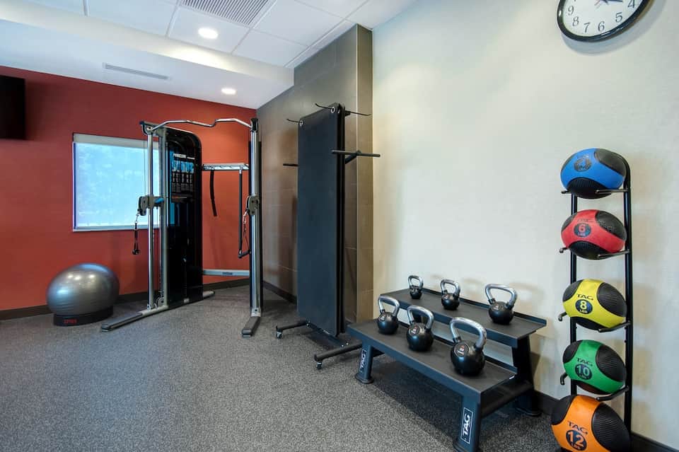 Fitness center with exercise equipment, kettlebells, medicine balls, and training machines