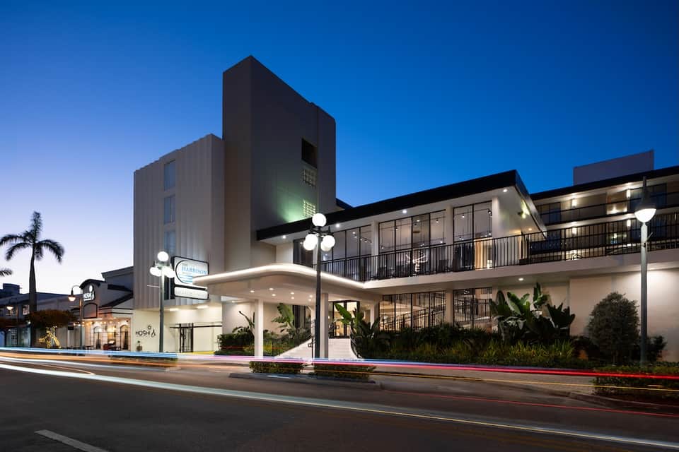 Contemporary hotel exterior at dusk with modern architecture and illuminated entrance