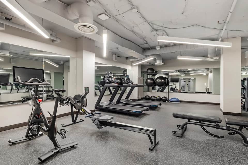 Modern fitness center with treadmills, stationary bikes, and equipment