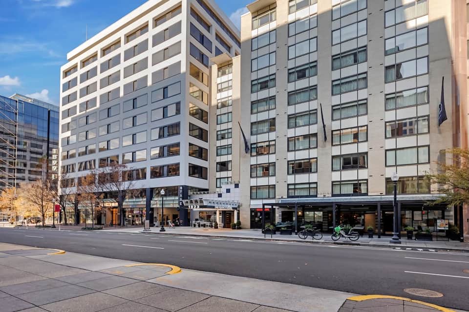 Contemporary urban hotel building exterior with multi-story architecture and ground-level retail