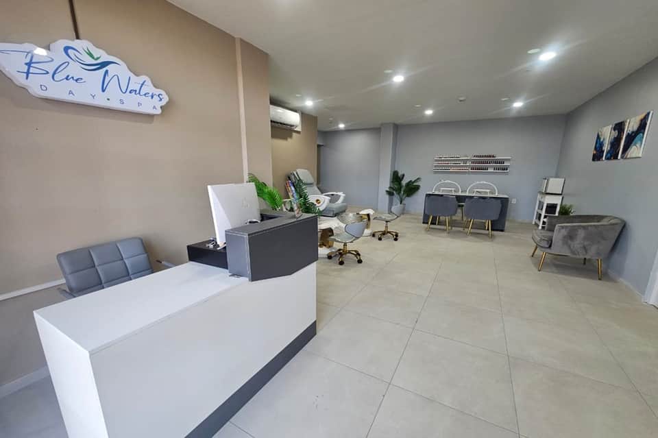 Modern hotel lobby reception desk with blue accent walls and contemporary seating area