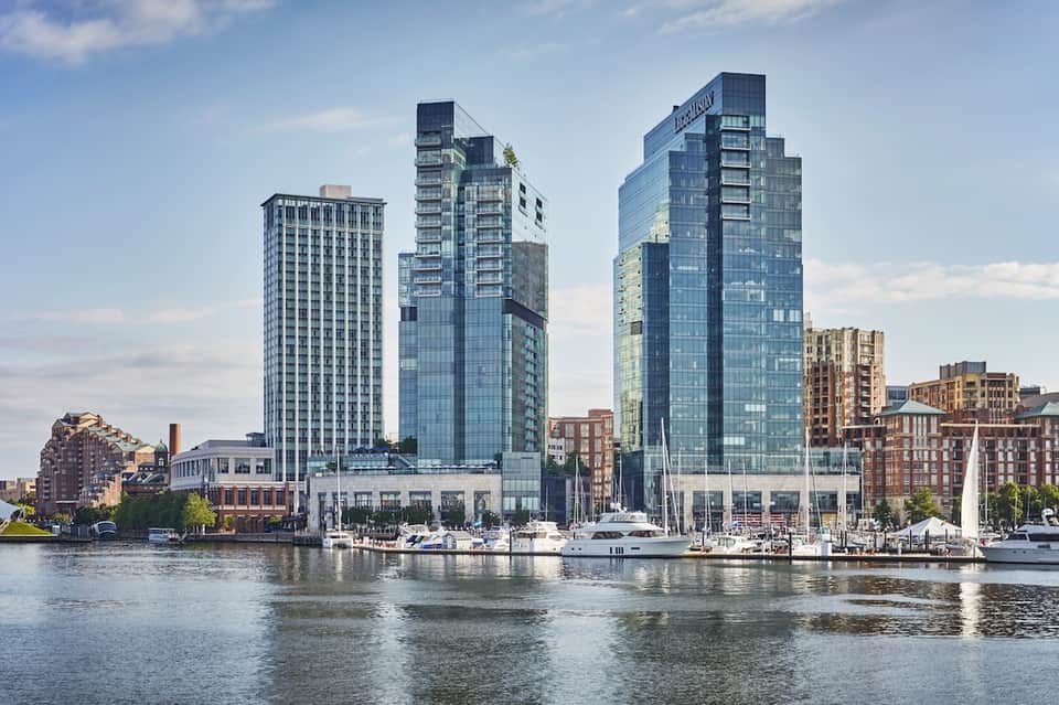 Waterfront high-rise buildings and residential towers along urban riverfront with docked boats