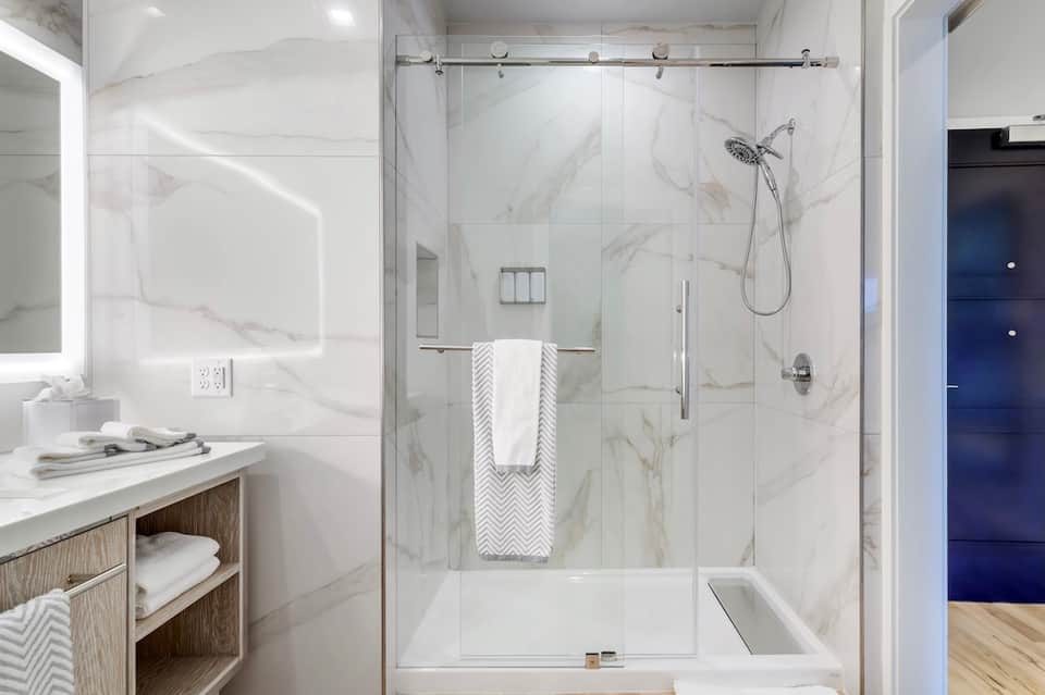 Luxury bathroom with marble shower enclosure and contemporary finishes