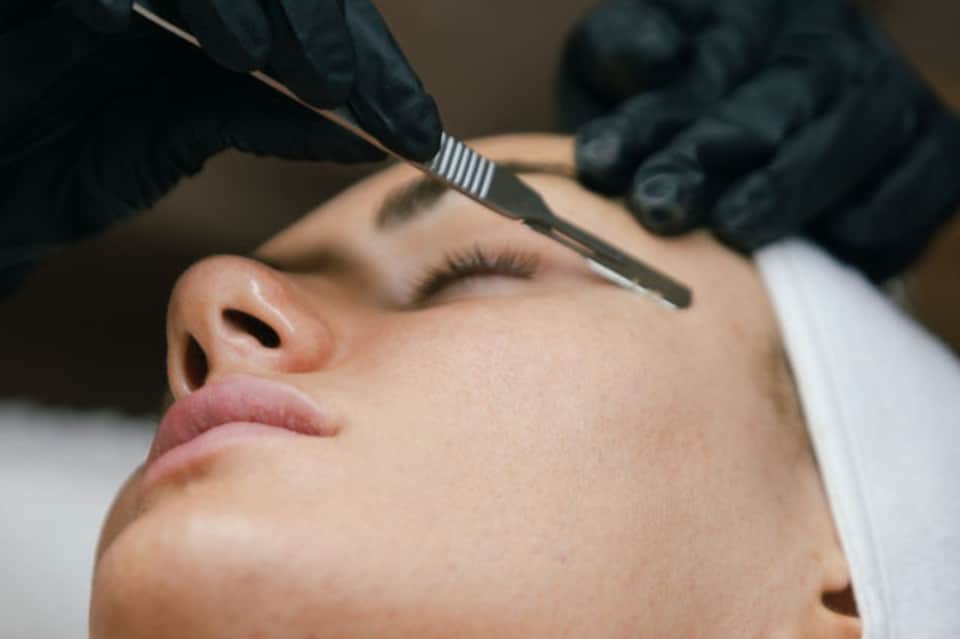 Close-up of facial treatment being applied with brush during spa procedure