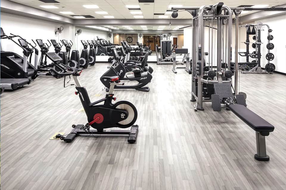Modern fitness center with exercise bikes, weight machines, and strength training equipment