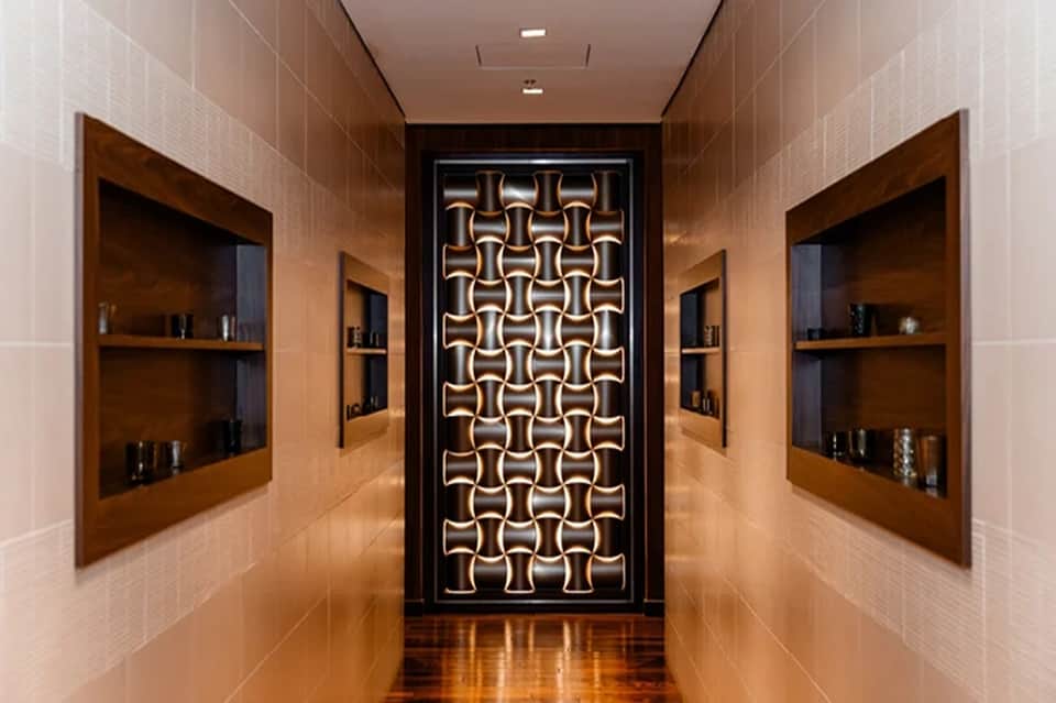 Luxury spa corridor with neon geometric wall art and wooden shelving alcoves