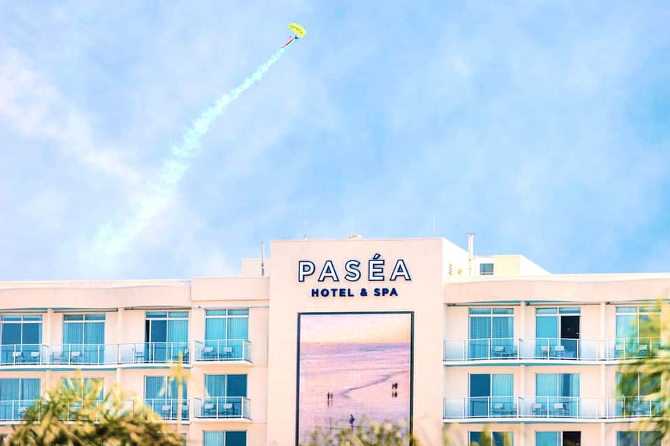 Paséa Hotel & Spa building facade with yellow kite flying above against blue sky