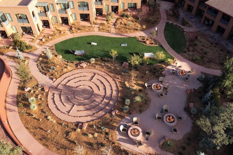 Aerial view of resort courtyard with spiral fire pit pattern and surrounding apartments