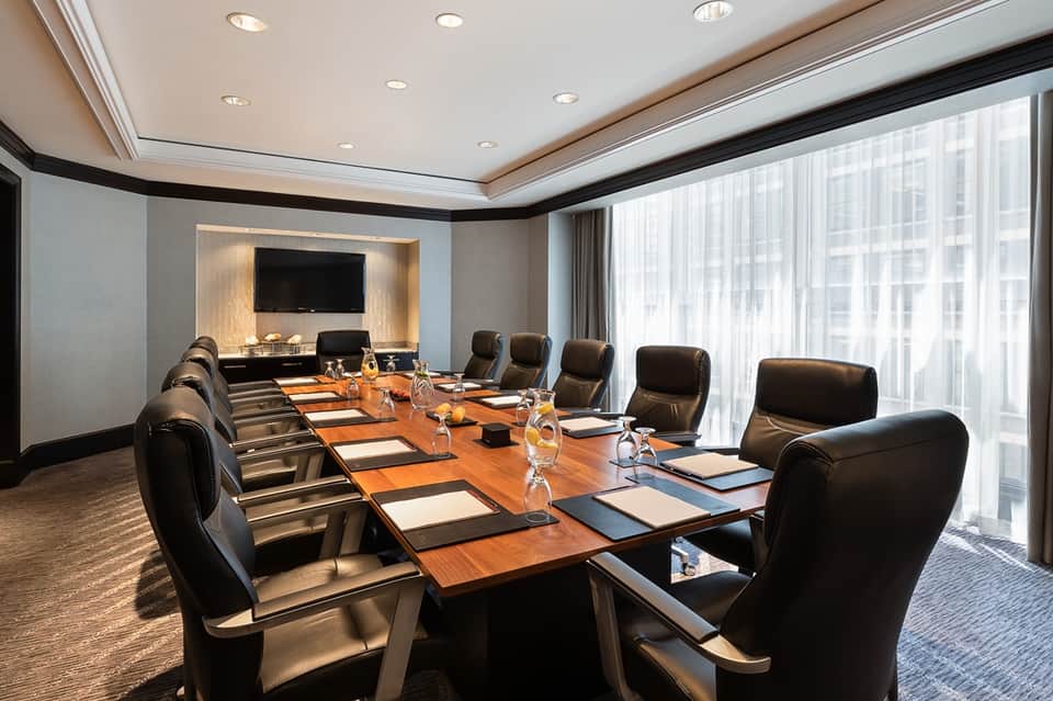 Executive boardroom with long wooden table and professional seating