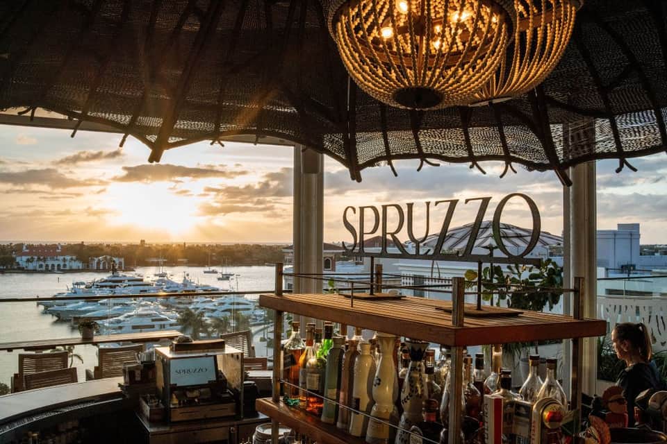 Waterfront restaurant terrace with golden ceiling details and harbor views