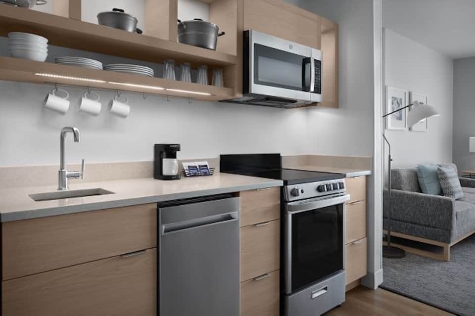 Modern kitchen with light wood cabinetry, stainless appliances, and clean design