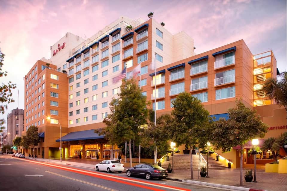 Marriott hotel exterior at dusk with illuminated orange brick facade and street view