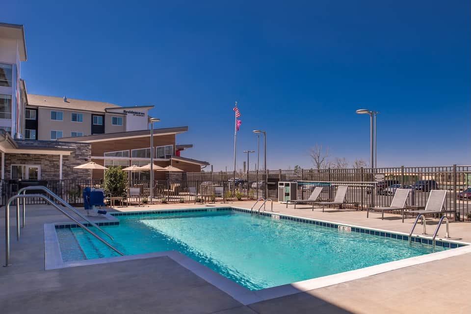Resort outdoor pool with lap lane, lounge chairs, and desert landscaping