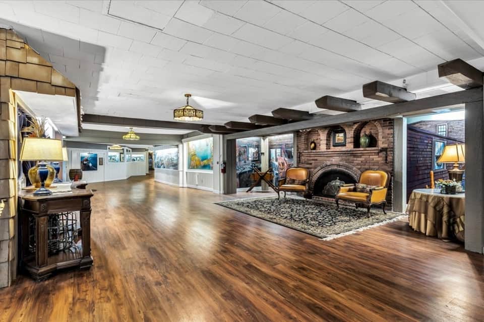 Elegant hotel lobby with wooden beams, fireplace, and gallery wall artwork