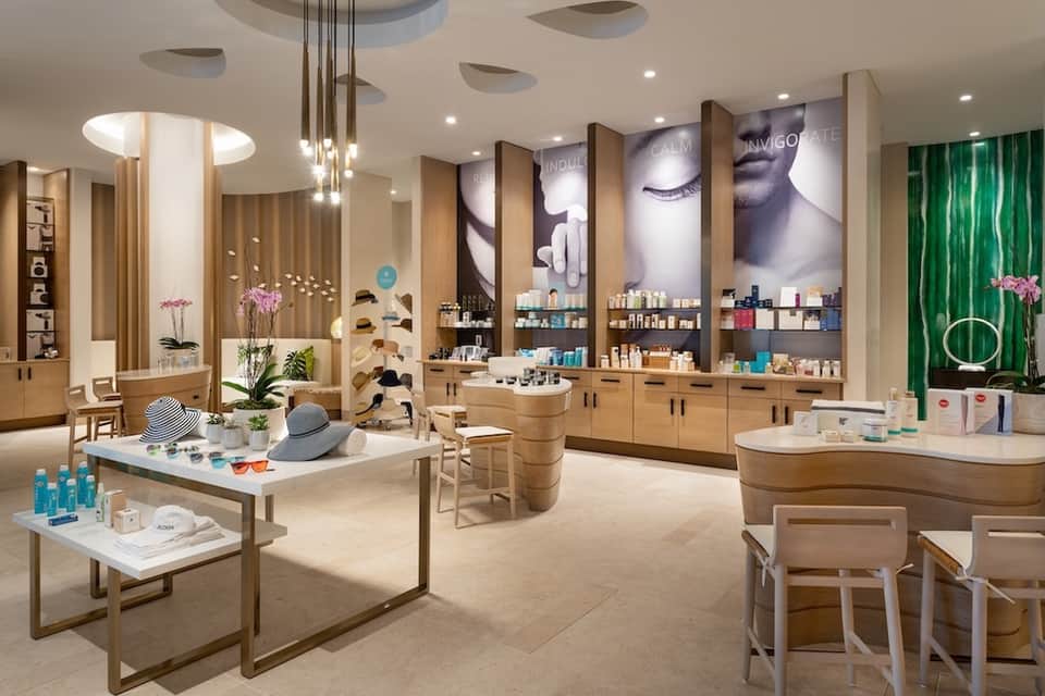 Upscale resort spa boutique with wooden cabinetry, beauty products, professional lighting, and modern interior design