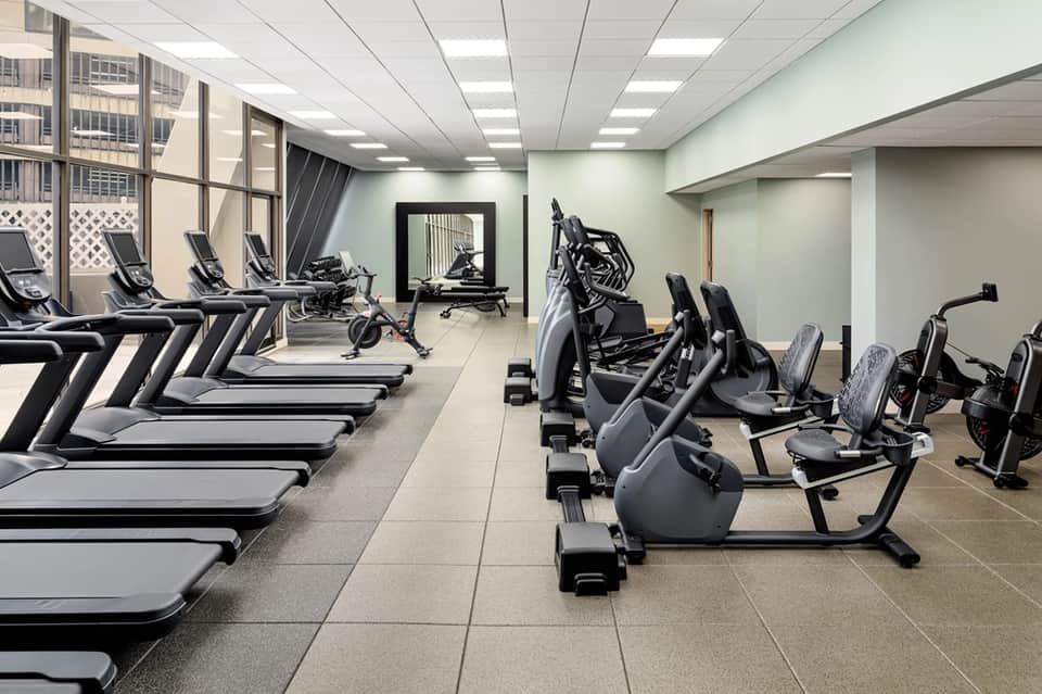 Modern fitness center with treadmills, stationary bikes, and weight equipment