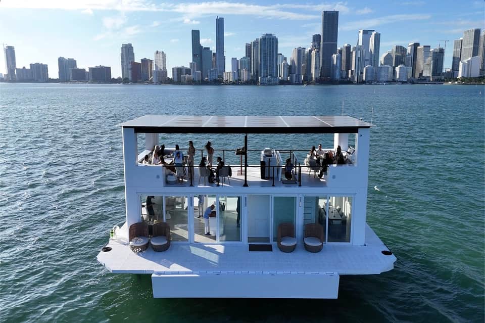 Multi-level white boat on water with Chicago skyline in the background