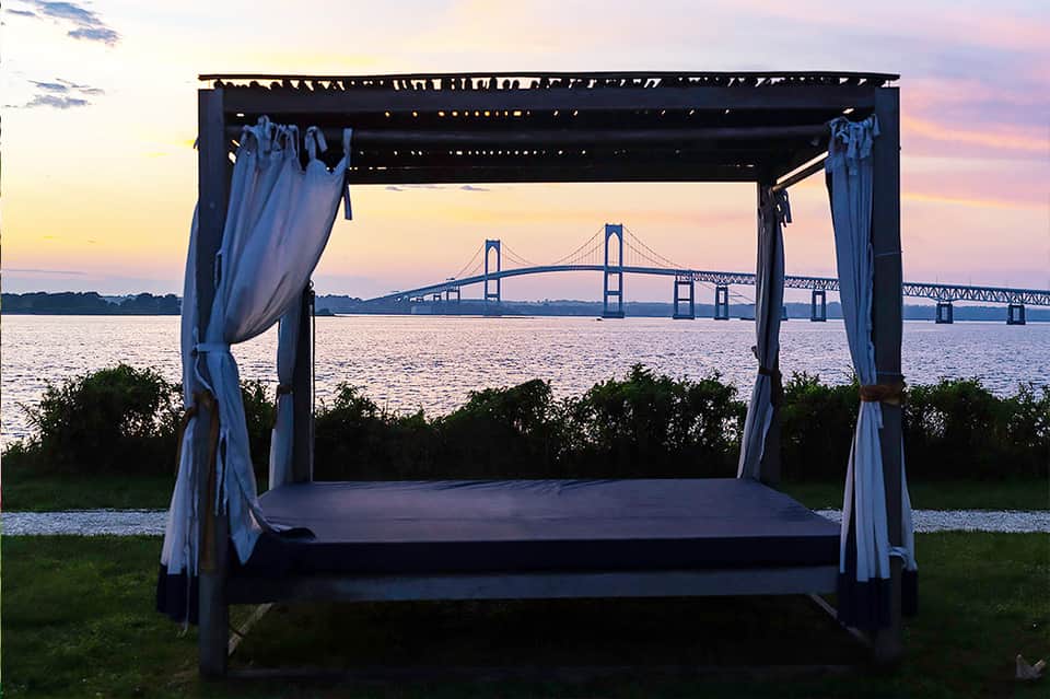 Waterfront gazebo with ocean views of large suspension bridge at twilight